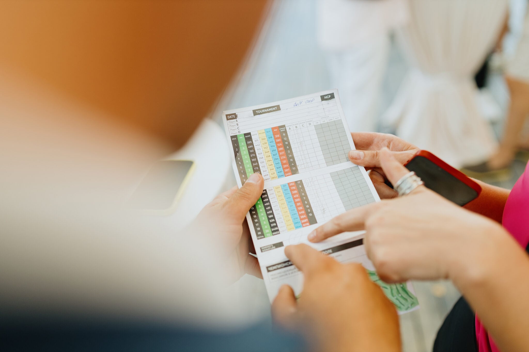 A golfer marks a score on a golf scorecard | Source: Adobe Stock odds of beating your handicap