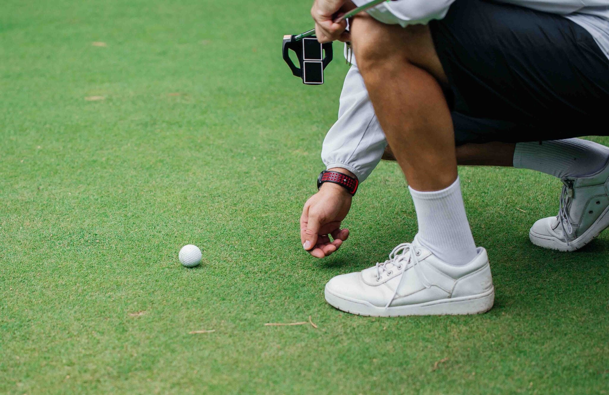 A golfer marking a ball on a green | Source: Supplied marking golf ball rules