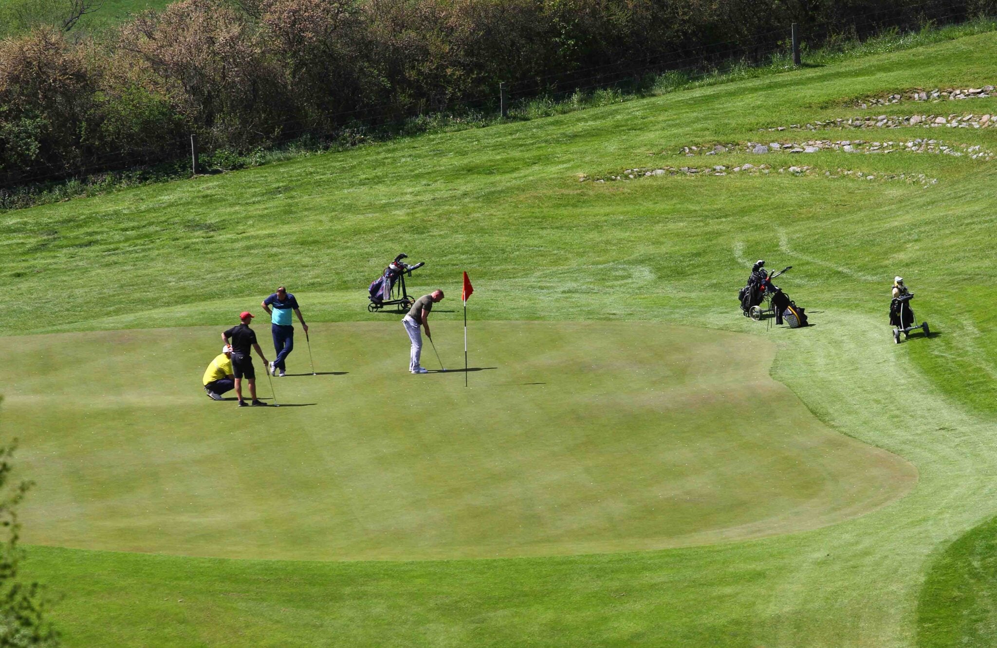 foursomes Golfers at a green | Source: Adobe Stock