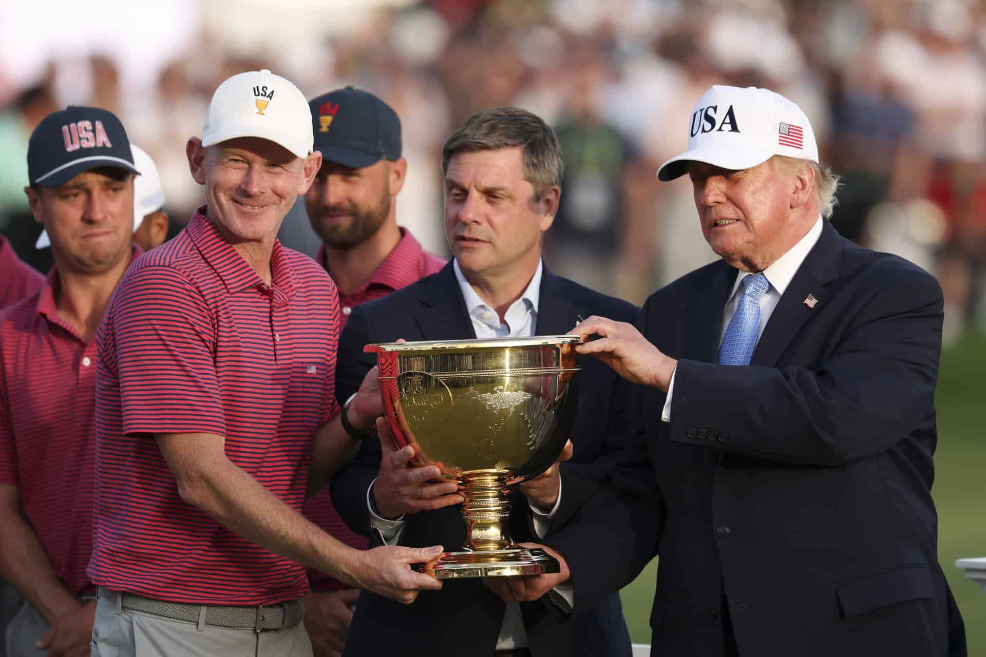 Captain Brandt Snedeker of the U.S. Team lifts the trophy with President Donald Trump | Source: Luke Hales/Getty Images