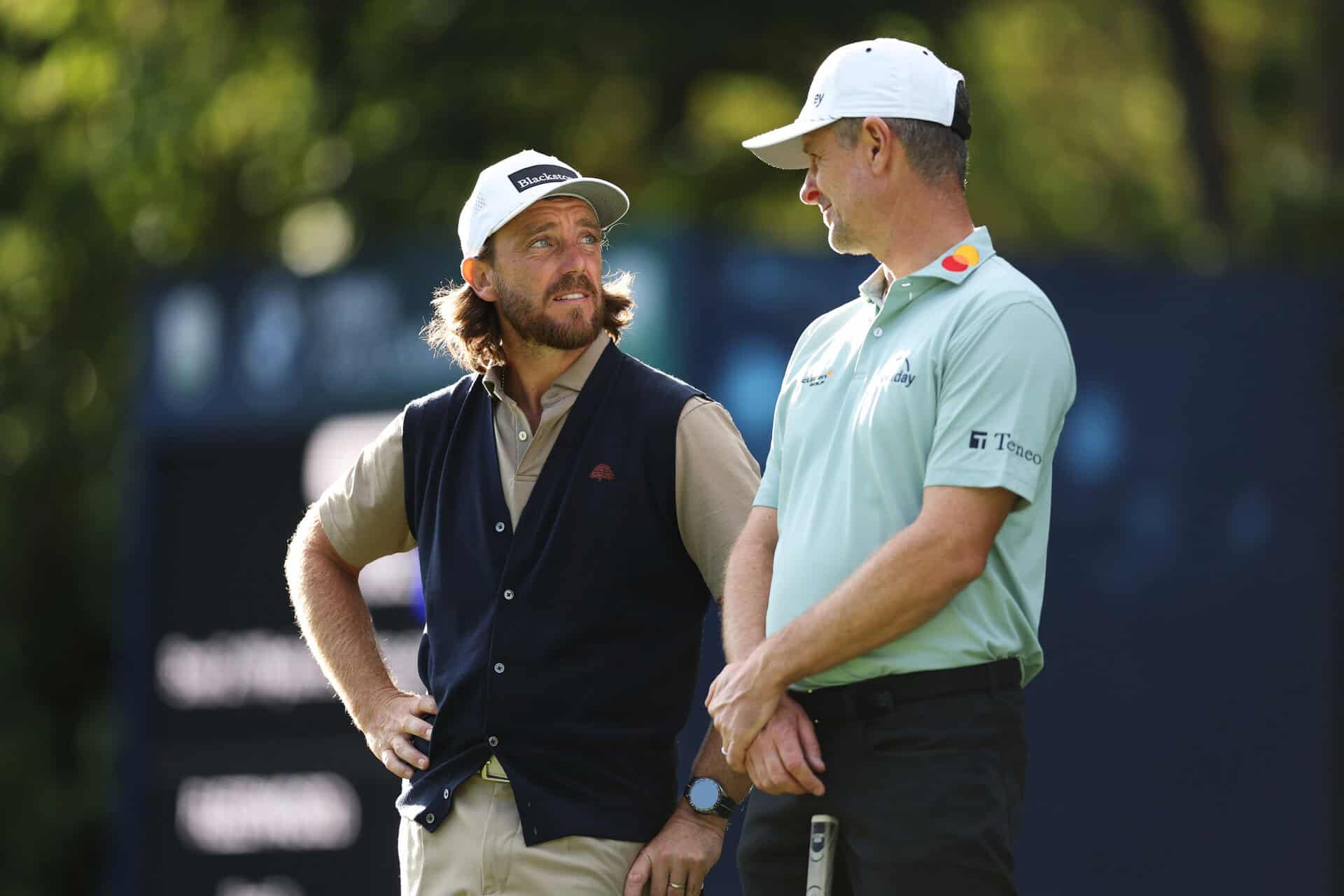 VIRGINIA WATER, ENGLAND - SEPTEMBER 17: Tommy Fleetwood of England and Justin Rose of England speak on the 16th green on day one of the BMW PGA Championship at 